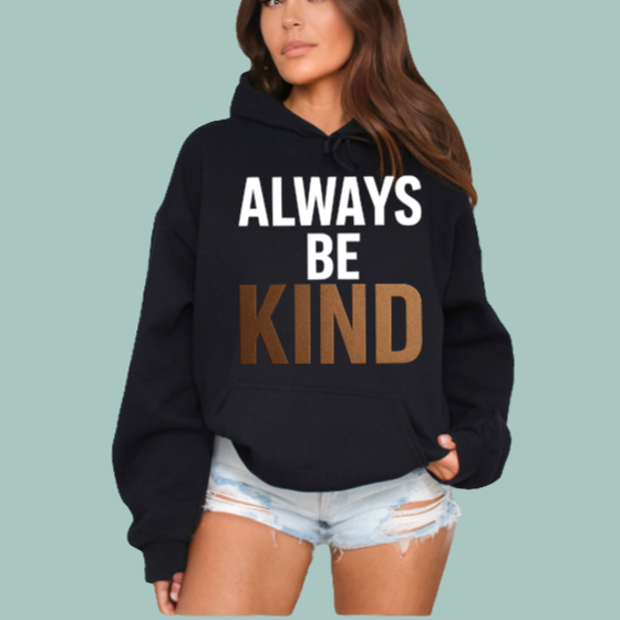 Person wearing a black hoodie with 'Always Be Kind' text on a light blue background