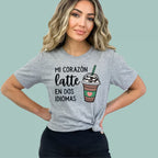 Grey bilingual pride shirt for women, "Mi Corazón Late En Dos Idiomas" design by Alexander Crafts.