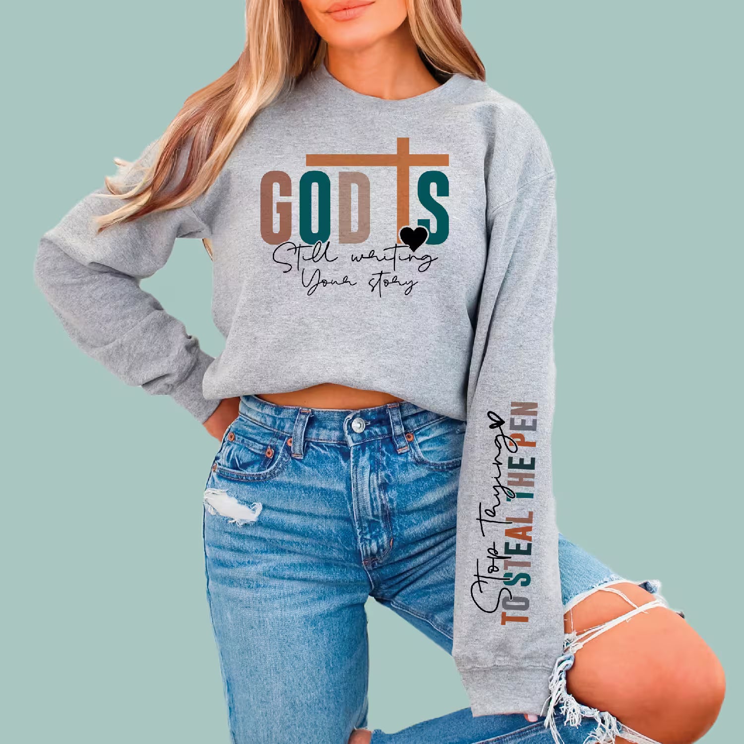Grey comfortable graphic sweatshirt with Christian faith message and "Stop Stealing the Pen" quote.