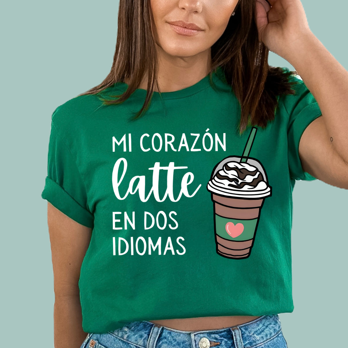 Kelly Green bilingual teacher shirt featuring "Mi Corazón Late En Dos Idiomas" text and a coffee heart graphic.