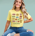 Woman wearing a yellow Multilingual Teacher Speech Bubble shirt featuring "Teacher" in different languages.