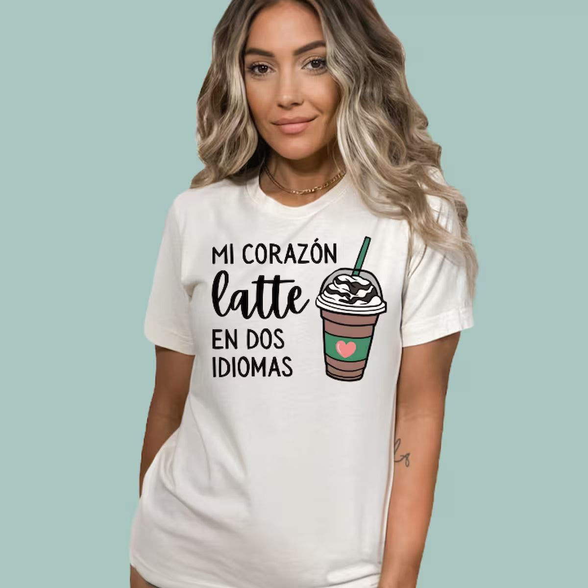 Natural-colored tee for bilingual classroom teachers, featuring a modern heart and latte graphic.