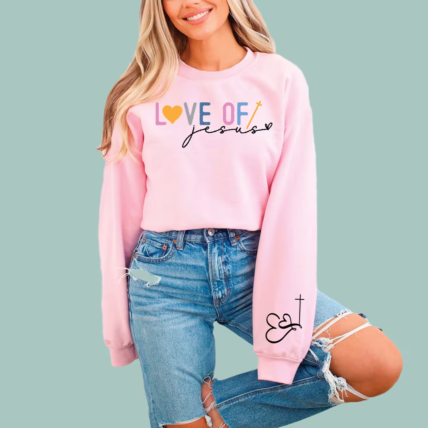 Woman wearing a pink Love of Jesus modern Christian sweatshirt, a perfect gift for faith-based minimalist style.