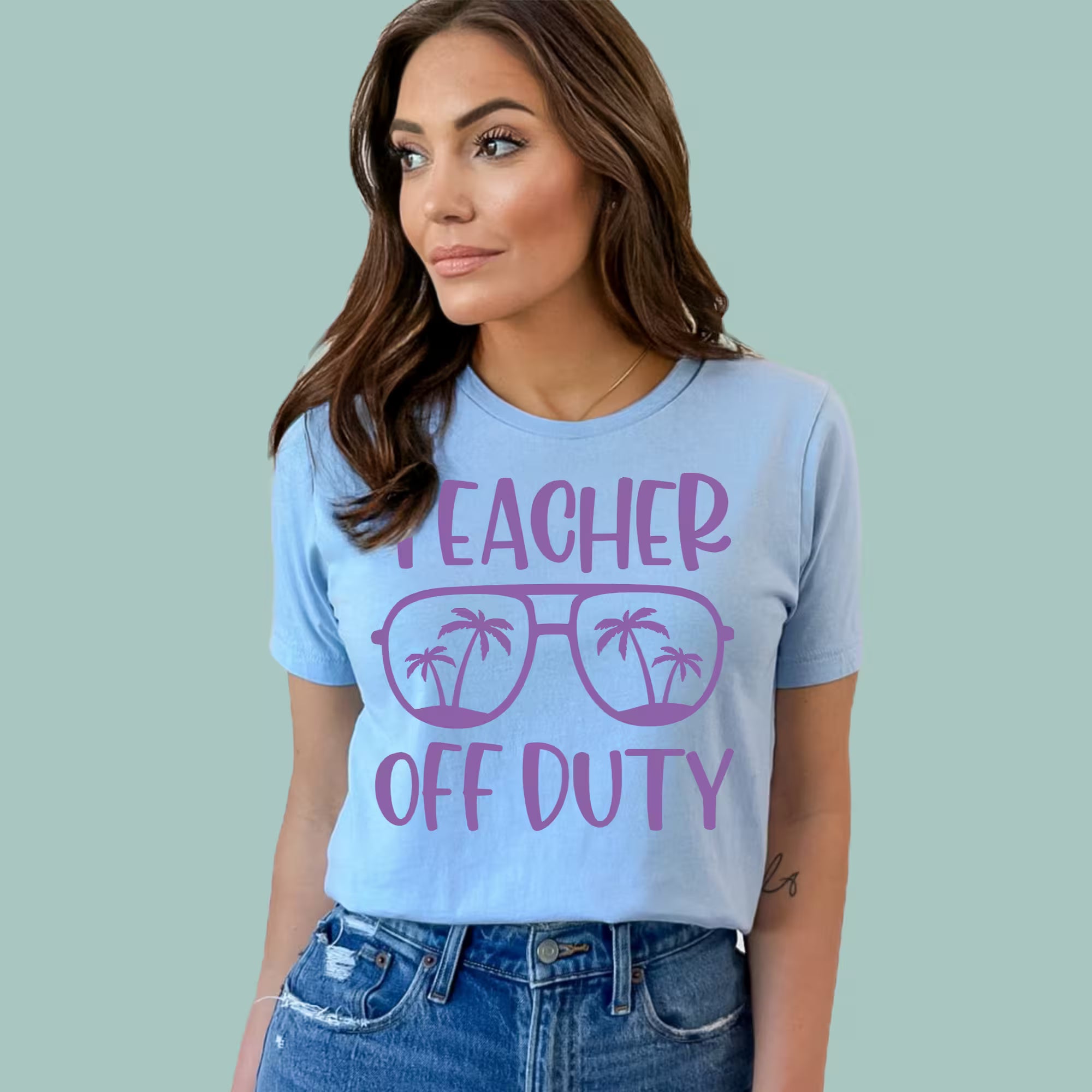 Light blue Teacher Vacation Mode shirt featuring a tropical sun and palm tree graphic.