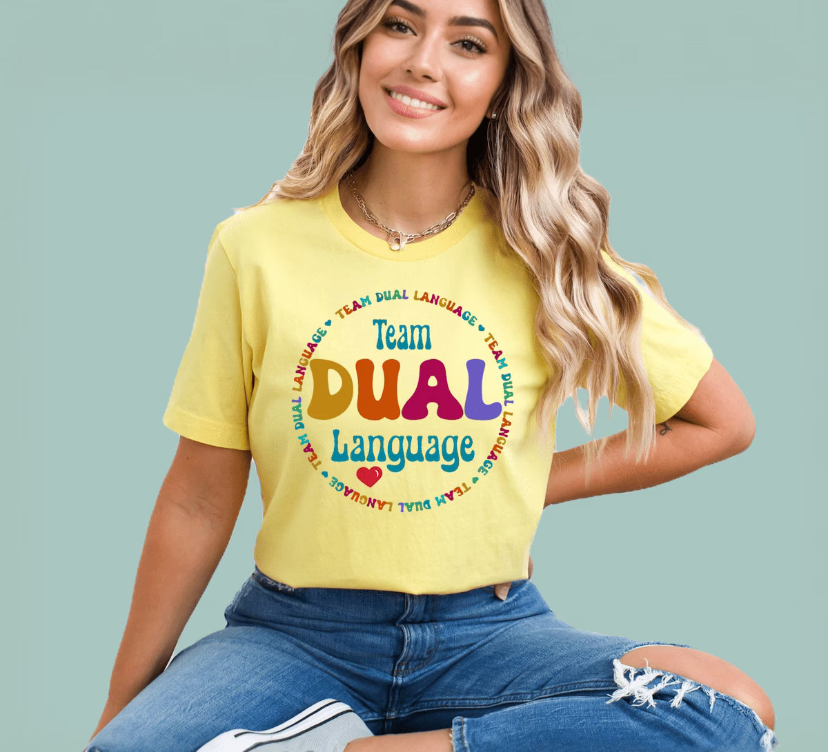 Yellow teacher appreciation tee with a bold "Team Dual Language" speech bubble design by Alexander Crafts.