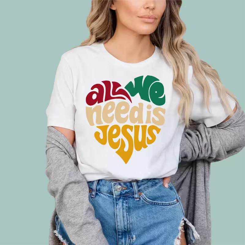 White "All We Need Is Jesus" cotton shirt, comfortable and stylish apparel for believers.