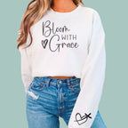 White "Bloom With Grace" floral pullover sweatshirt, soft and comfortable apparel for daily faith wear.