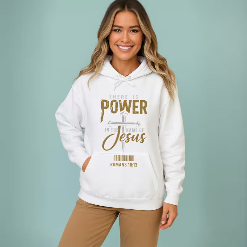 White Christian graphic hoodie featuring "There Is Power in The Name of Jesus" distressed metallic design.