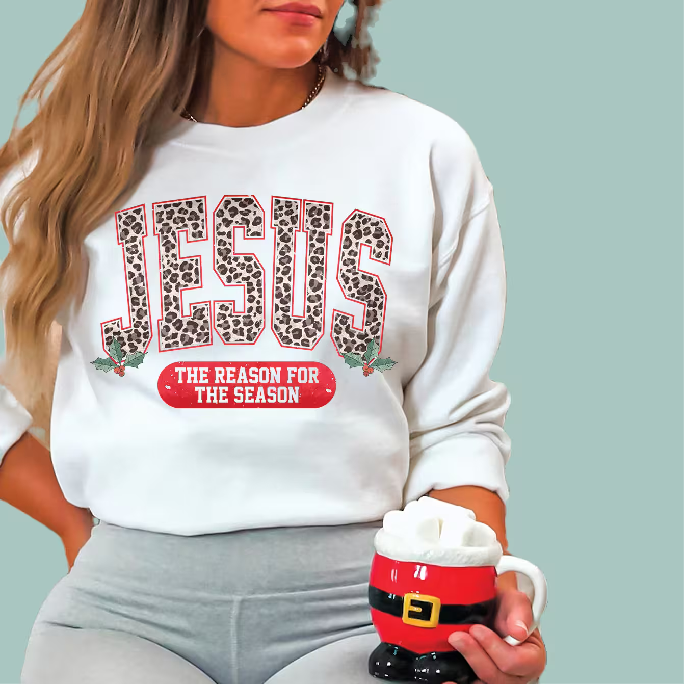 White holiday faith sweatshirt featuring "Jesus The Reason For The Season" graphic design.