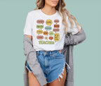 White world language educator shirt with a colorful multilingual speech bubble graphic by Alexander Crafts.
