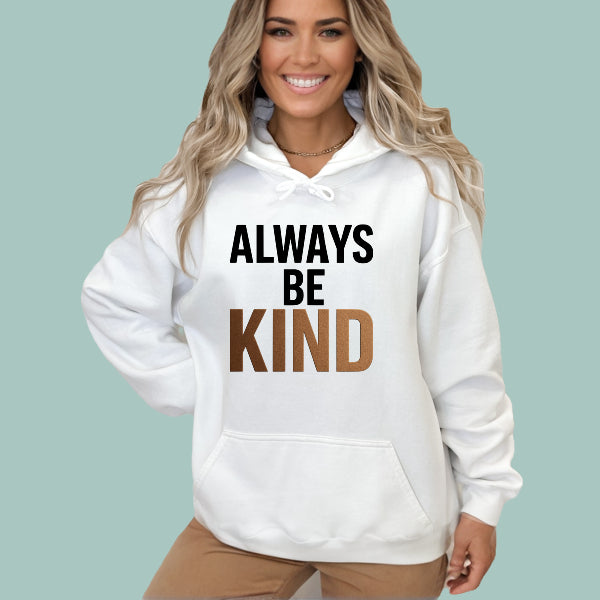 Woman wearing a white hoodie with 'ALWAYS BE KIND' text on a light green background